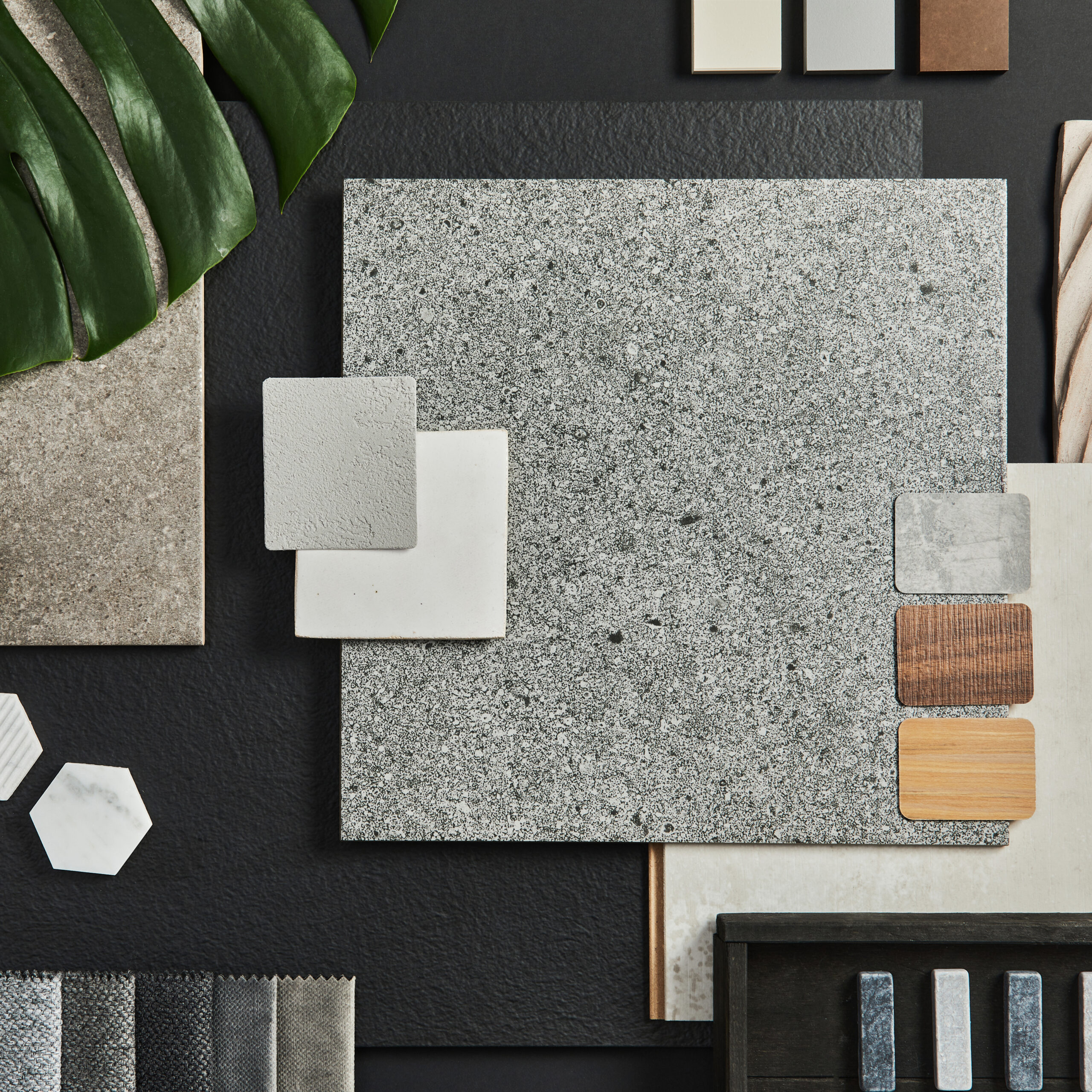 Flat lay composition of creative black architect moodboard with samples of building, textile and natural materials and personal accessories. Top view, black backgroung, template.